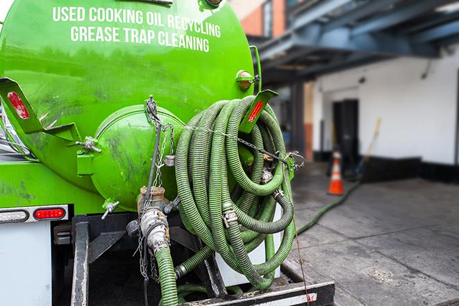 a grease trap pumping truck at a restaurant in Altamont